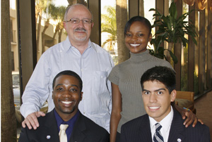 MDC President Dr. Eduardo J. Padrón, student scholarship recipients Rose-Taina Honorat, and seated from left, Gershom Jones and Christian Moreno.