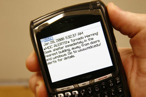 Person holding cellphone with screen displaying MDC alert