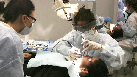 Medical Campus Dentist working on a patient's teeth