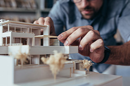 Architecture student building a model home