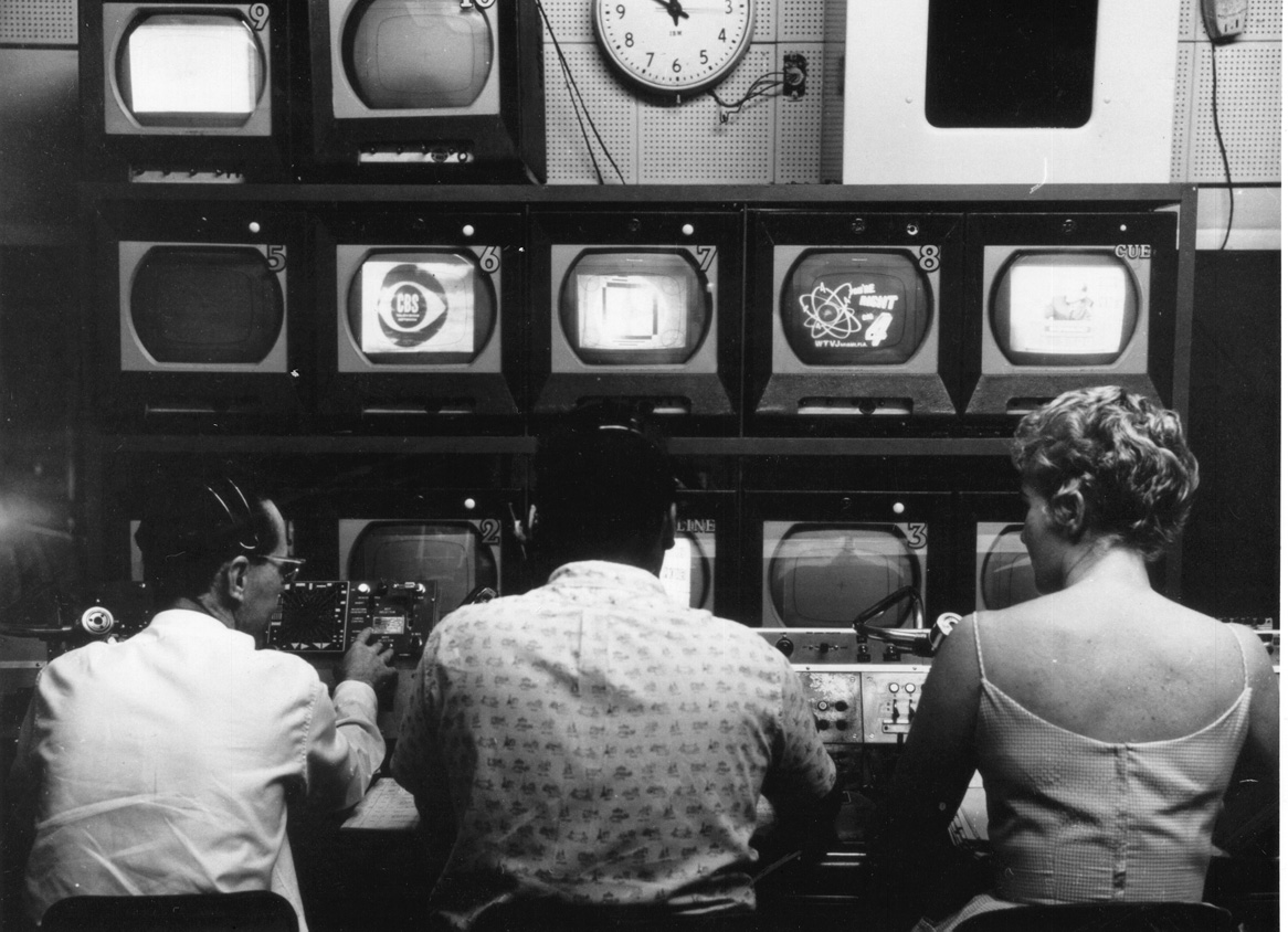 People in front of TV control console