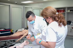 Phlebotomy technician trains with a student