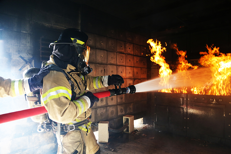 Student putting out a fire during a training course