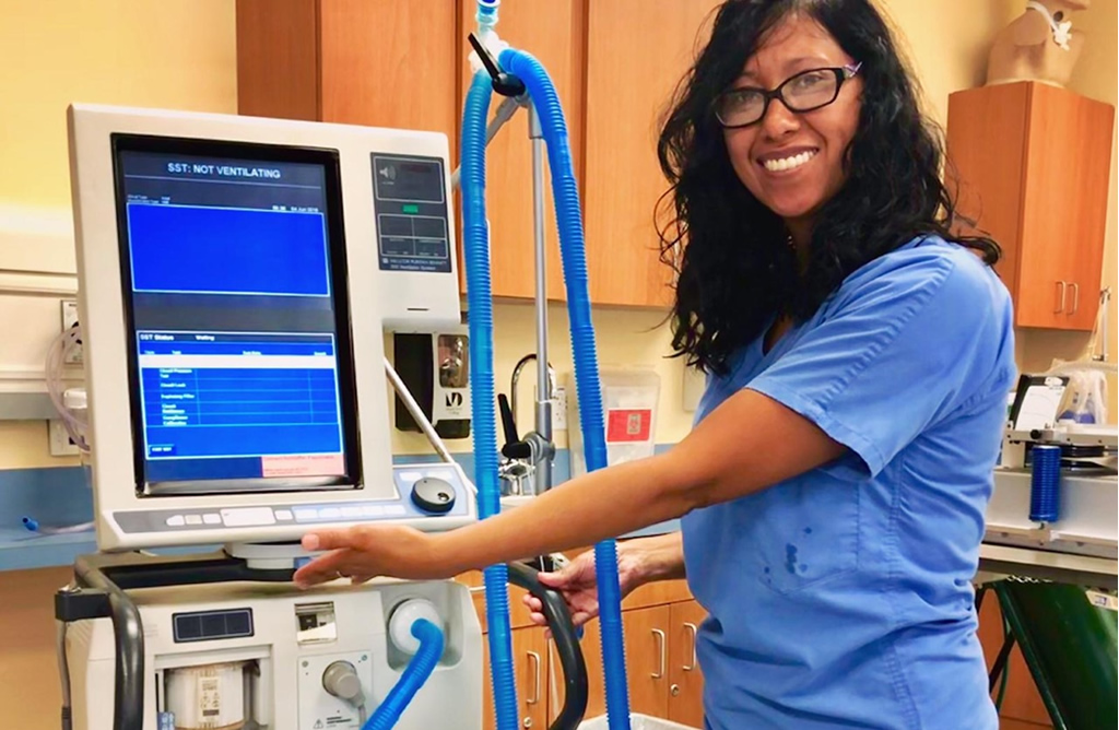 MDC Respiratory Therapist student stands by a ventalator