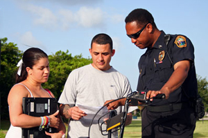 A public safety officer guiding two students