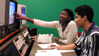 Teacher instructing student in an audio-visual center