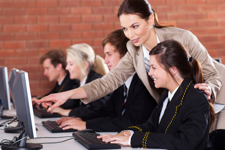 professor helping a student on the computer