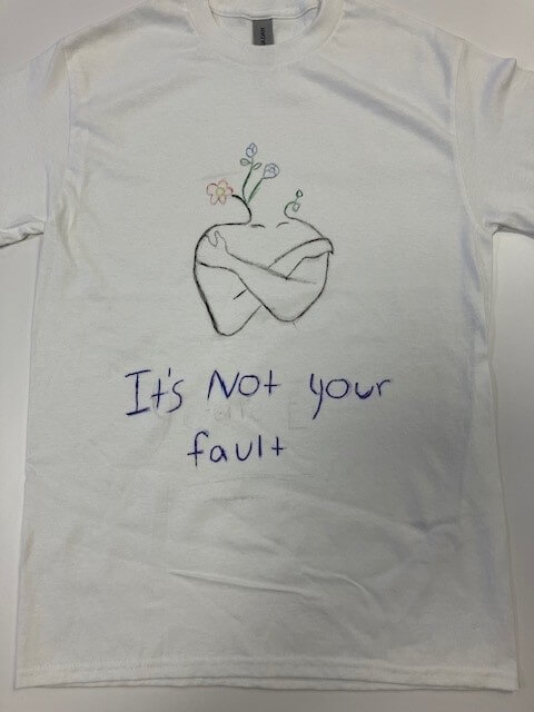 white tee shirt with the words 'it's not your fault' hand painted on it