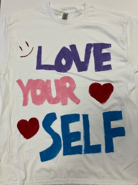 white tee shirt with the words 'love yourself' hand painted on it