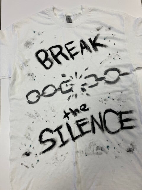 white tee shirt with the words 'break the silence' with a broken chain hand painted on it