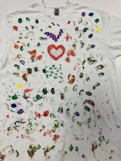 white tee shirt with a heard and many fingerprints hand painted on it