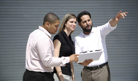 Woman and two men discussing business plan