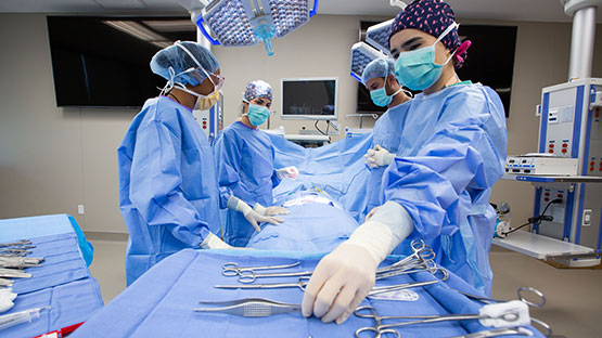 surgeons and technologists in an operating room performing a surgery