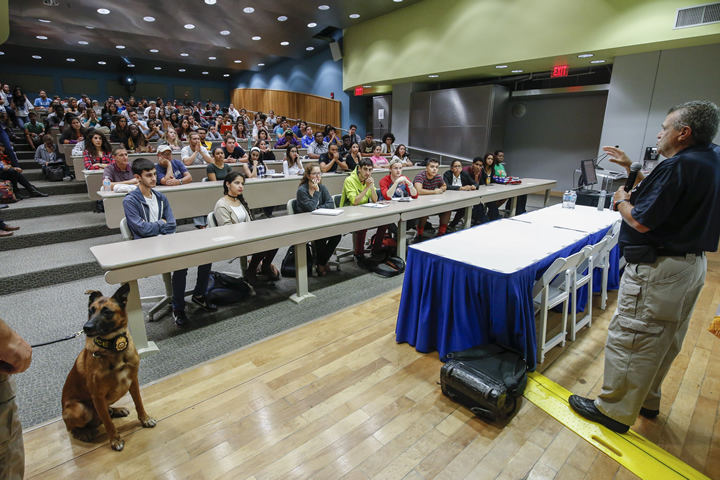 Professor gives lecture in large auditorium filled with students